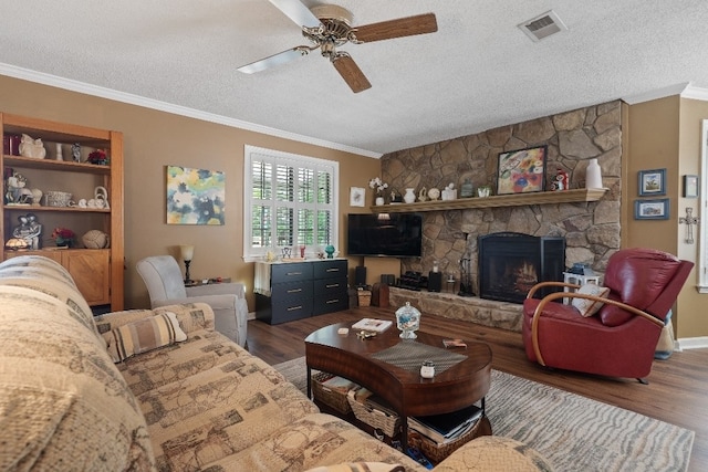 102 E Montego Ct, Milledgeville, GA 31061 - living area with wood finished floors, a textured ceiling, crown molding, a ceiling fan, and a stone fireplace