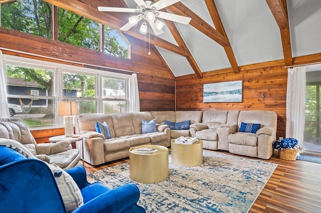 living room with hardwood / wood-style flooring, beamed ceiling, high vaulted ceiling, and plenty of natural light