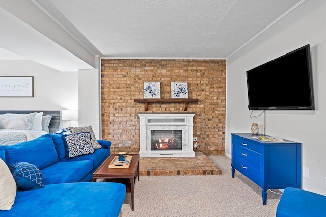 living room with a textured ceiling, carpet flooring, ornamental molding, and a fireplace