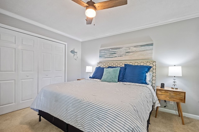 carpeted bedroom featuring crown molding, a closet, and ceiling fan