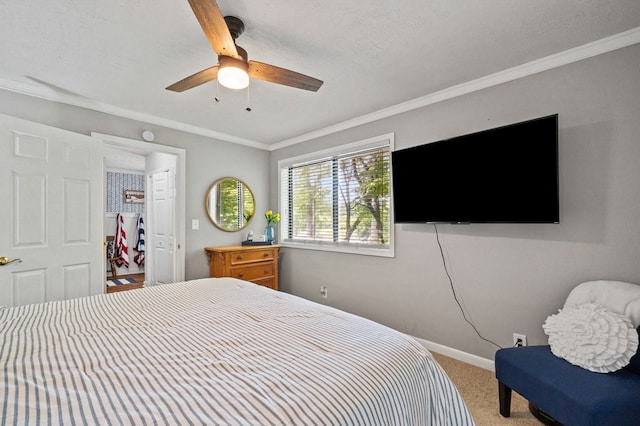 carpeted bedroom with ceiling fan, a spacious closet, and crown molding