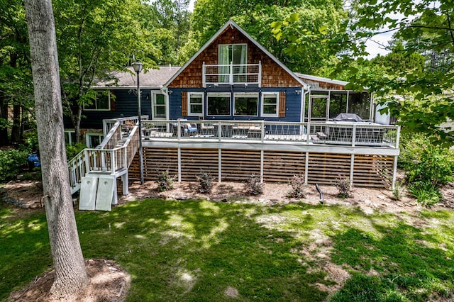 back of property with a lawn and a wooden deck