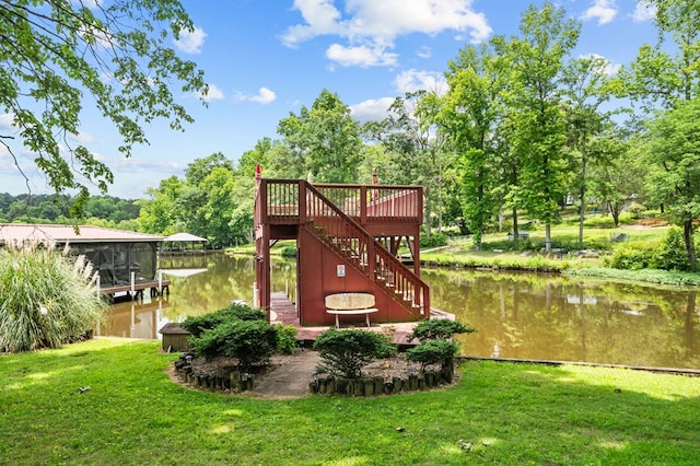 exterior space featuring a lawn and a water view