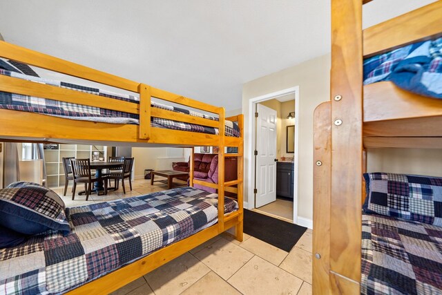 bedroom featuring tile patterned floors and baseboards