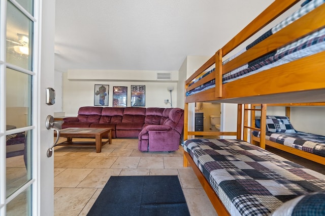 bedroom featuring tile patterned floors and visible vents