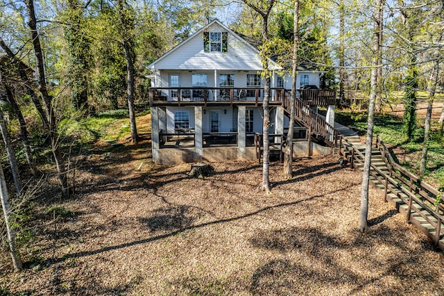 rear view of property with a patio area, stairway, and a wooden deck