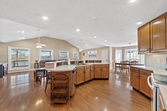 kitchen with a ceiling fan, a sink, light countertops, white electric stove, and light wood finished floors