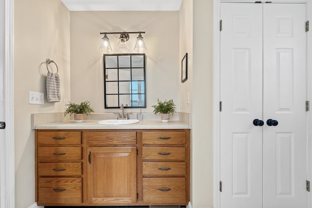 bathroom with a closet and vanity