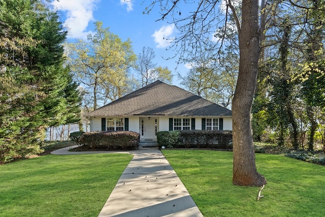 bungalow-style house with a front yard and roof with shingles