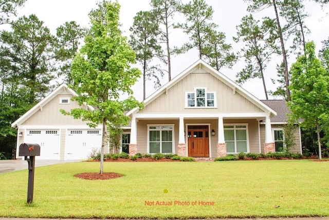 craftsman-style home with covered porch, driveway, a front lawn, and board and batten siding