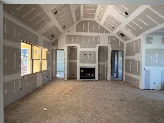 unfurnished living room featuring high vaulted ceiling and visible vents