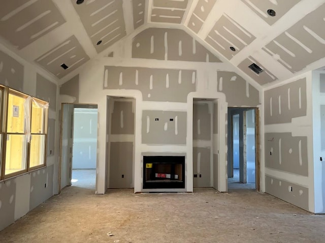 unfurnished living room featuring high vaulted ceiling and visible vents