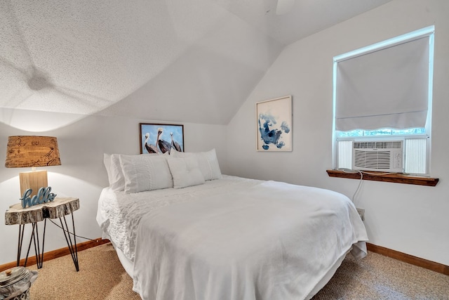 bedroom with carpet, a textured ceiling, vaulted ceiling, and ceiling fan