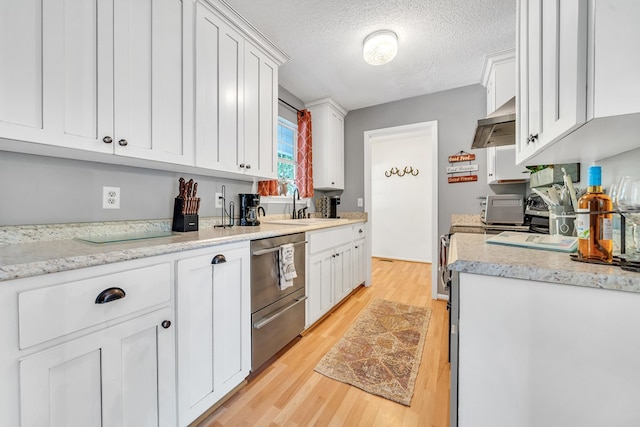 kitchen featuring a textured ceiling, sink, light hardwood / wood-style floors, white cabinetry, and range hood