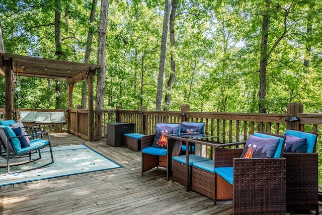 deck featuring a pergola and an outdoor hangout area