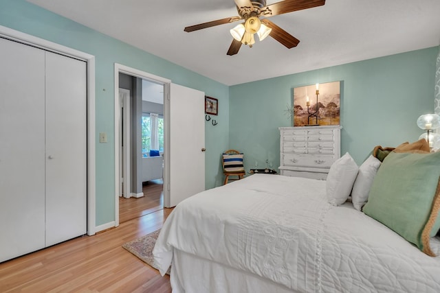 bedroom with ceiling fan, a closet, and light hardwood / wood-style flooring