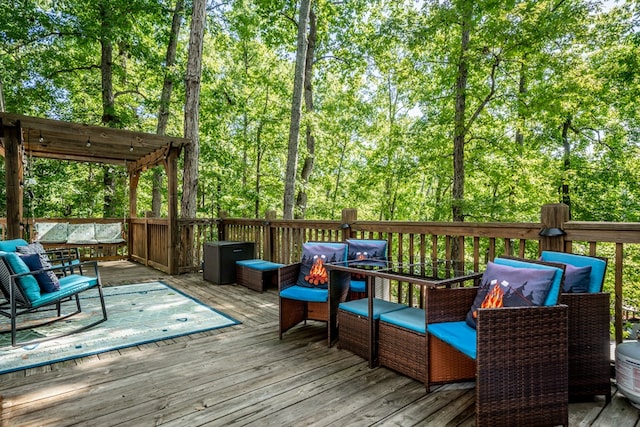 deck featuring a pergola and outdoor lounge area