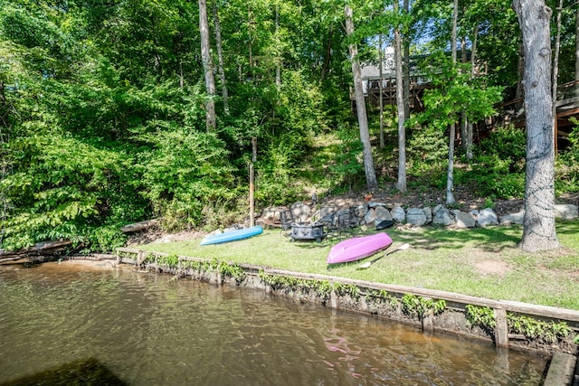 view of community with a water view and a yard