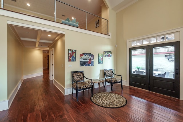 entryway featuring beam ceiling, wood-type flooring, crown molding, and coffered ceiling