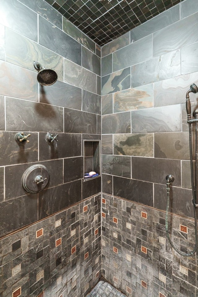 bathroom with tiled shower