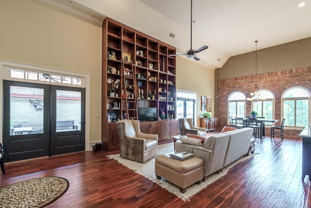 living room featuring high vaulted ceiling, ceiling fan with notable chandelier, and hardwood / wood-style flooring