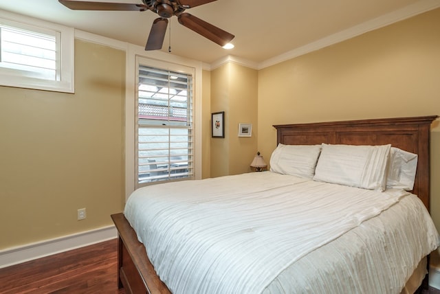 bedroom with crown molding, ceiling fan, and dark wood-type flooring