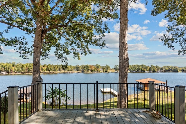 wooden deck featuring a dock and a water view