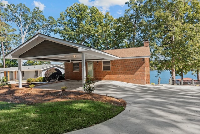 exterior space with a water view and a carport