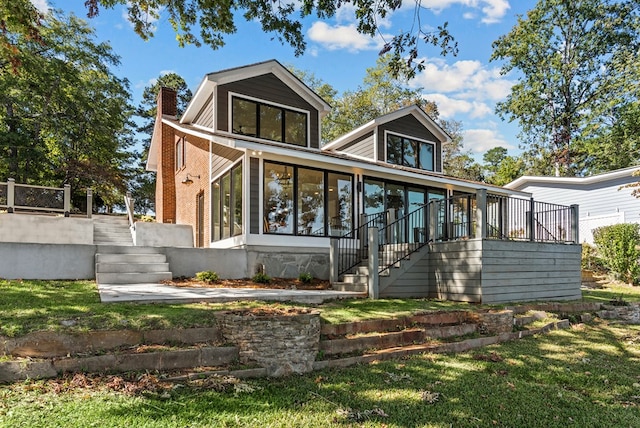 rear view of property featuring a sunroom