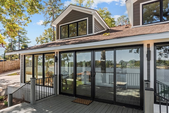 exterior space featuring a deck with water view