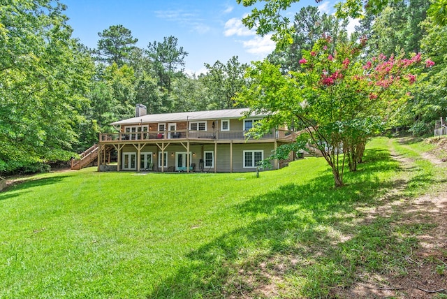 back of house with a lawn and a deck