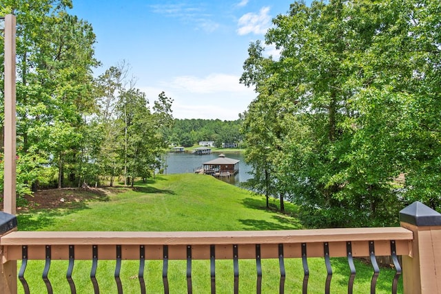 view of yard featuring a dock and a water view