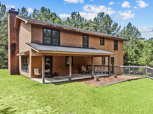 rear view of house with a patio area and a yard