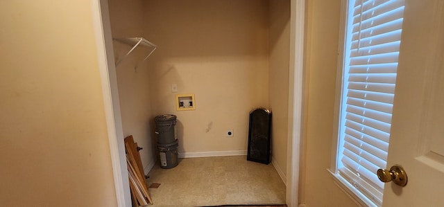 clothes washing area with laundry area, hookup for a washing machine, electric dryer hookup, and baseboards