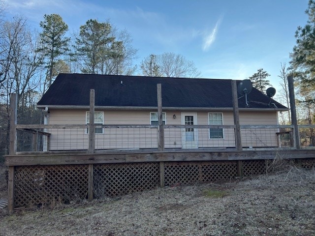 back of house with a wooden deck