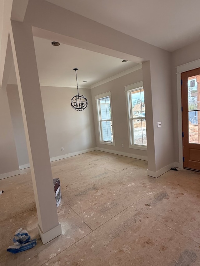 unfurnished dining area featuring crown molding