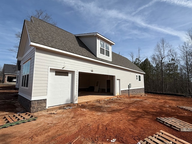 view of side of property featuring a garage