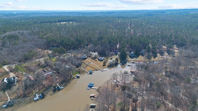 aerial view featuring a forest view and a water view