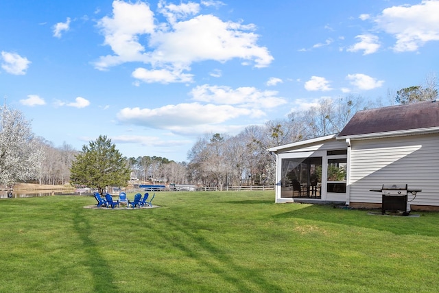 view of yard with fence and a sunroom