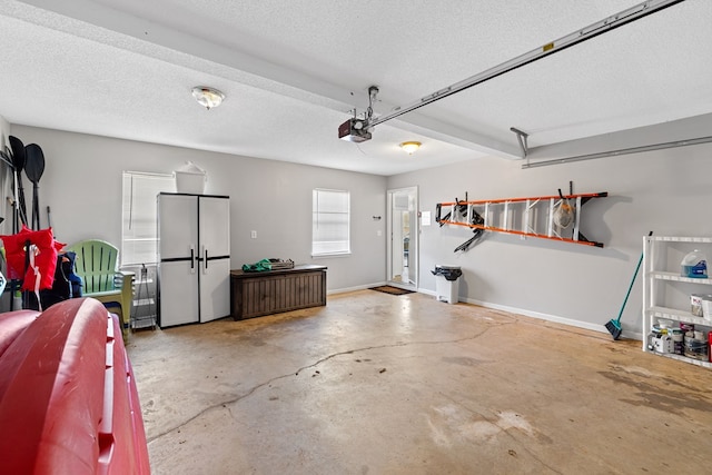 garage featuring baseboards and a garage door opener