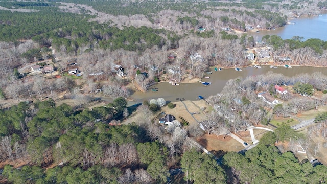 birds eye view of property featuring a view of trees and a water view