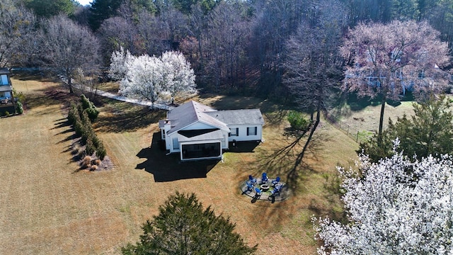 birds eye view of property featuring a view of trees