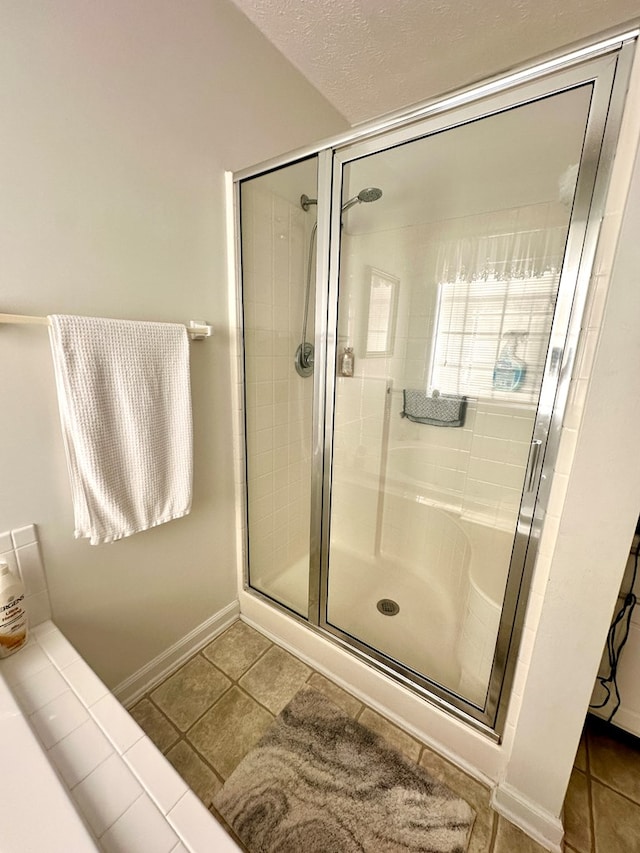 full bath with a stall shower and tile patterned floors