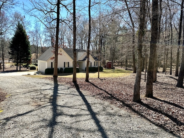 view of side of home featuring driveway and an attached garage