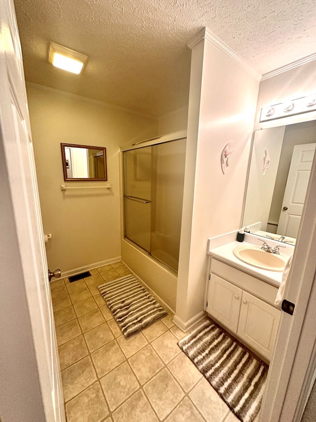 full bathroom featuring bath / shower combo with glass door, visible vents, vanity, a textured ceiling, and tile patterned floors