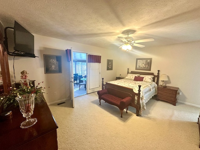 carpeted bedroom featuring access to exterior, ceiling fan, a textured ceiling, and baseboards