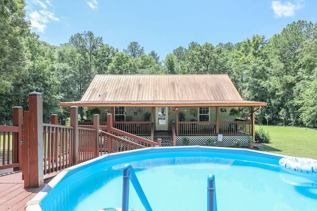 287 Napier Rd, Eatonton, GA 31024 - swimming pool featuring a lawn, a view of trees, and a deck