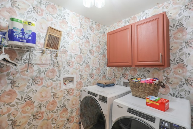 287 Napier Rd, Eatonton, GA 31024 - laundry area with wallpapered walls, cabinet space, and washing machine and clothes dryer