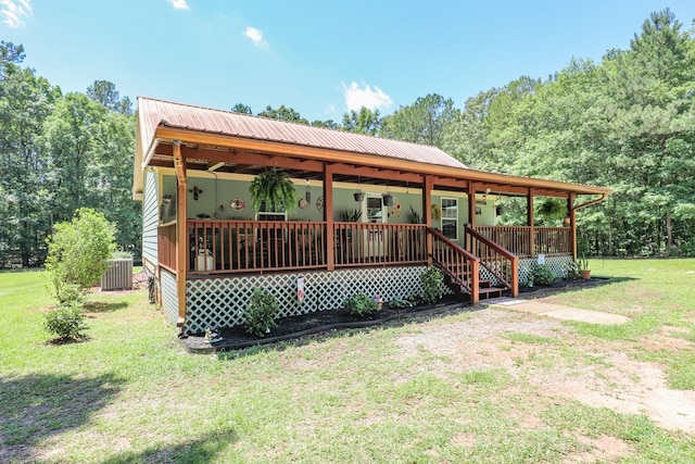 287 Napier Rd, Eatonton, GA 31024 - view of front of property featuring a front lawn, cooling unit, a porch, and metal roof