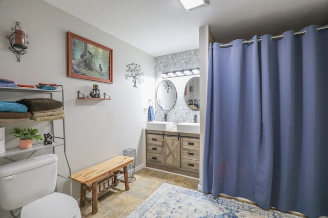 287 Napier Rd, Eatonton, GA 31024 - bathroom featuring toilet, double vanity, curtained shower, and stone finish floors